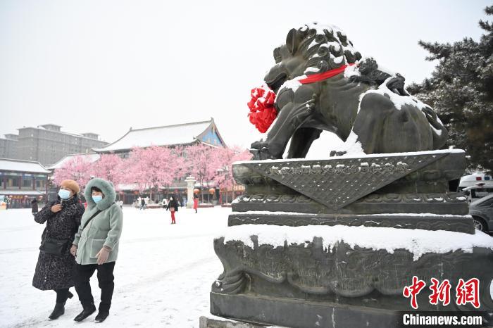 2月13日，民眾在呼和浩特市大召廣場雪中漫步?！⑽娜A 攝