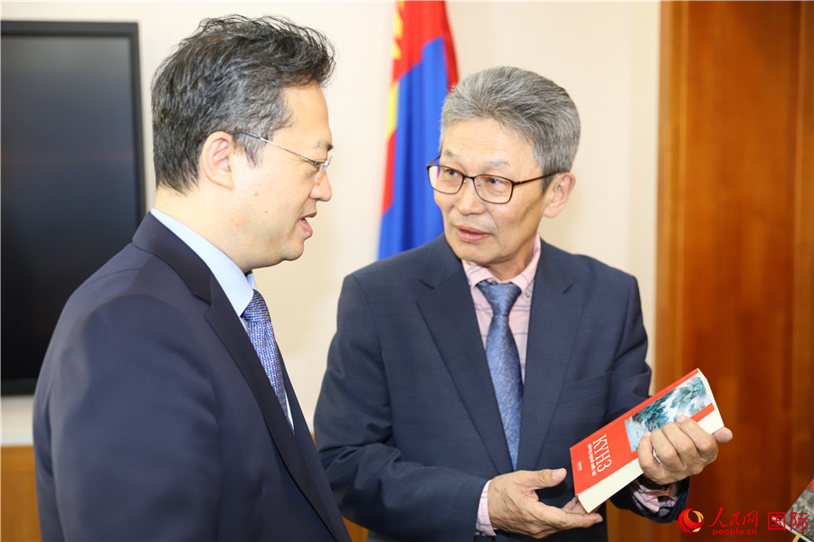 其米德策耶（右一）向李峙介紹翻譯成果。人民網(wǎng)記者 霍文攝