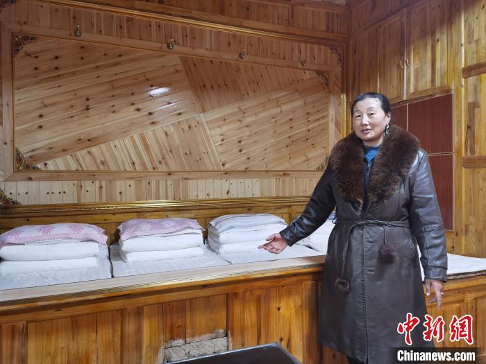 圖為德吉村村民鬧尖措介紹自家農(nóng)家樂?！∑钤鲚?攝